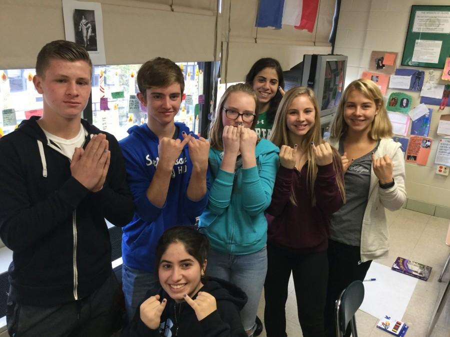 Students show they stand against bullying by painting their pinkies blue. 