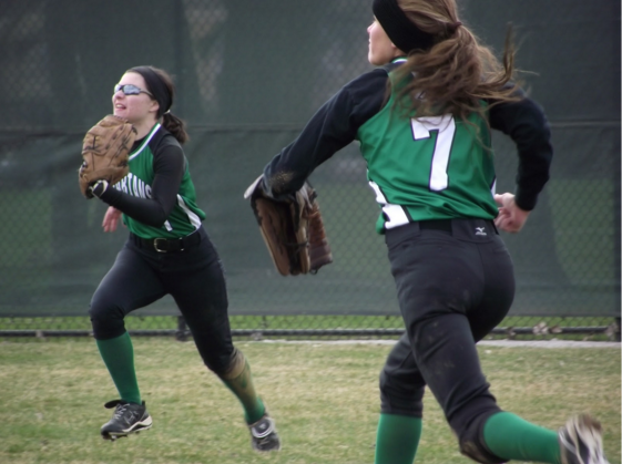 Maddy Pagliaro and Kara Melvin going for a fly ball.
