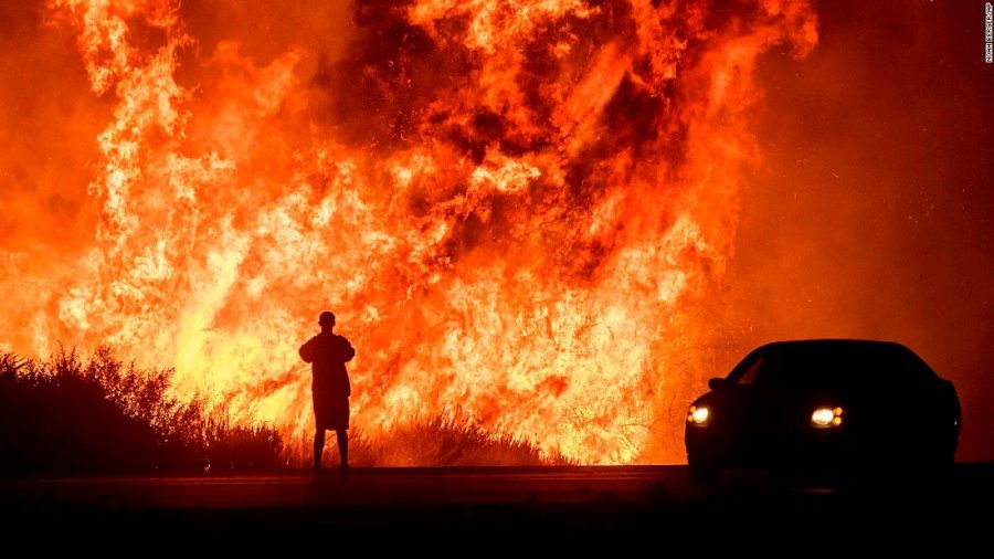 Someone watches flames from the California fire burn everything in its path.